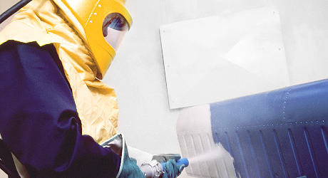 Image of a person working with sandblasting